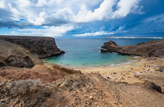 Sandy beach beach and rocky coast with dramatic sky, Playa de Papagayo, coastal landscape, Los Ajaches Natural Park, Lanzarote, Canary Islands, Spain