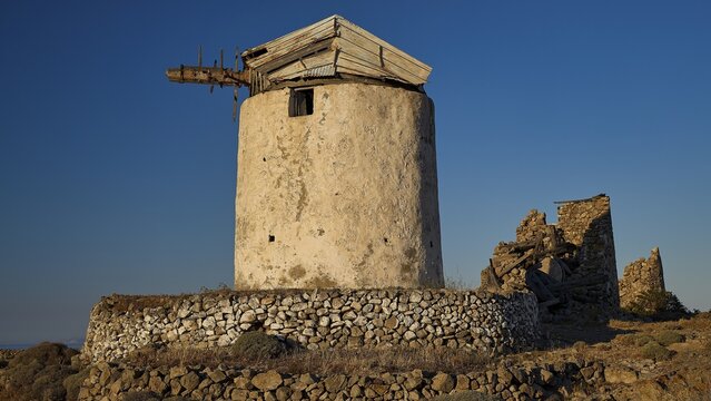 Windmill above Chorio on Mount Xaplovouni, old windmill and ruins in a barren landscape under clear sky, main town on Kimolos, Kimolos, Chorio, Kimolos island, neighboring island of Milos, Cyclades, Greek Islands, Greece