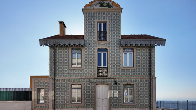 Historic Portuguese house with traditional green azulejo ceramic tile facade and classic architecture in Trafaria Almada near Lisbon Portugal