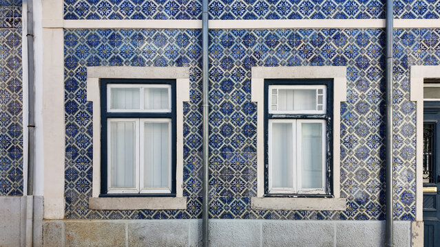Traditional blue azulejo tiled house facade with windows in Trafaria Portugal