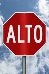 Red stop Alto Spanish sign with sky © Karen Roach