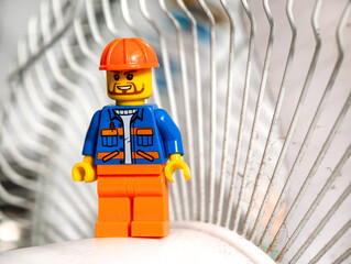 Fototapeta premium Russia, St. Petersburg, August 8, 2020 A close-up view of a Lego man sitting on a chair, with a focus on the character's facial expression