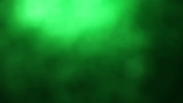 Una toma de cerca de un fondo abstracto de color verde y negro con un degradado ligero desenfocado en movimiento