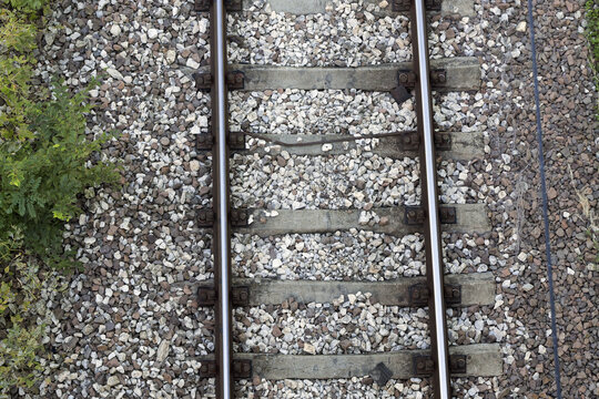 Railway tracks stretching into distance with ballast and sleepers