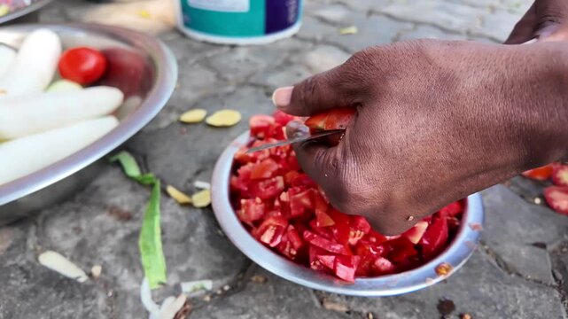 Food Worker Hand-Chopping Fresh Tomatoes Into Steel Bowl for Indian Cooking