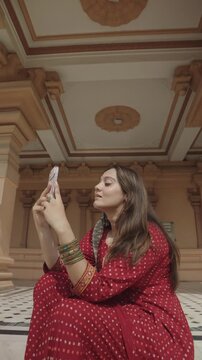 Indian woman exploring Chhatarpur Temple in Delhi while praying, walking and enjoying the temple surroundings