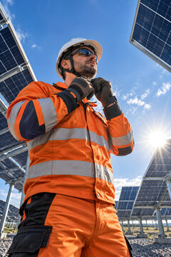 Solar worker preparing safety gear before field maintenance.