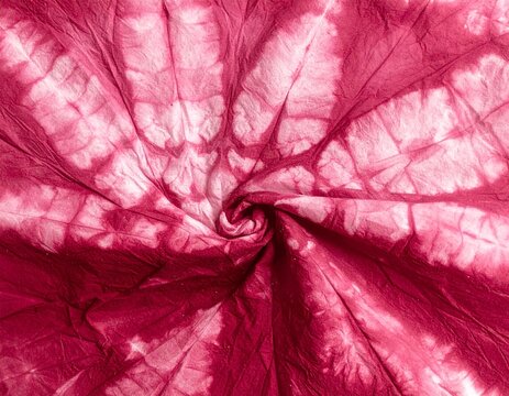 Pink batik dyed cotton with fine wax crackle lines, vibrant texture background with copy space