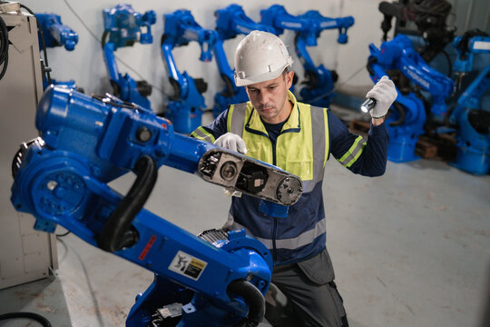 Industrial Engineer Supervising Robotic Automation In Modern Factory.