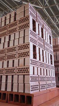 Stacks of hollow clay bricks loaded on a kiln car at a brick factory