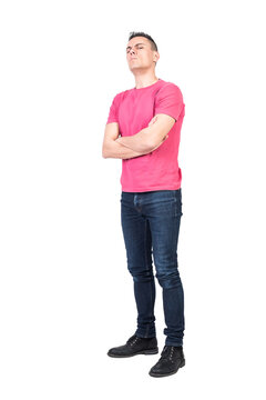 Full body skeptic man in casual clothes folding arms and looking at camera with frown
