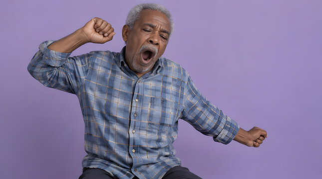 Sleepy senior man yawning and stretching.