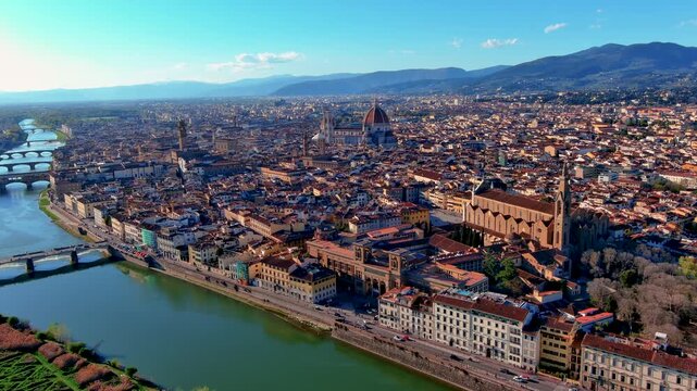Aerial drone view of Florence with the Duomo cathedral and Giotto bell tower, Palazzo Vecchio, Santa Croce basilica, the Arno river with Ponte Vecchio and terracotta rooftops, Tuscany, Italy.