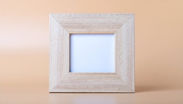 Empty square light wood photo frame with blank white space on a neutral beige background for mockup