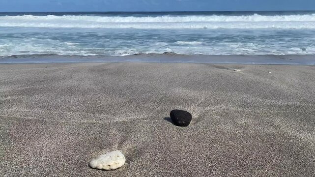 Black and white stones on Grande Anse beach at sunset, Reunion