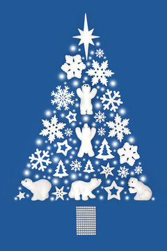 Christmas tree abstract with white decorations of polar bears, snowflakes, stars, trees, symbolic snow. North Pole cold theme concept on blue for greeting card.