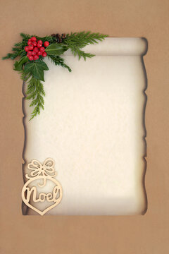 Christmas Noel sign, winter holly berries and flora on old paper scroll on brown paper background. Old fashioned Xmas concept for invitation or santa letter. 