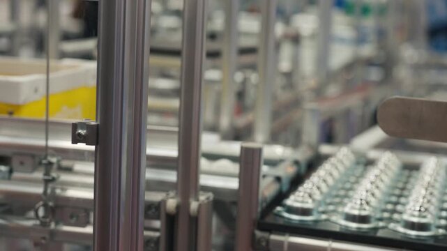 Smart industrial equipment loading cardboard boxes onto automated transport systems.