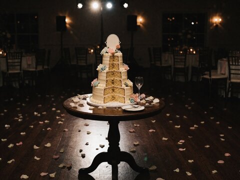 Partially eaten three-tier wedding cake with floral decorations