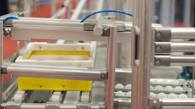 Driverless AGV logistics robot moving cardboard packages along warehouse aisle
