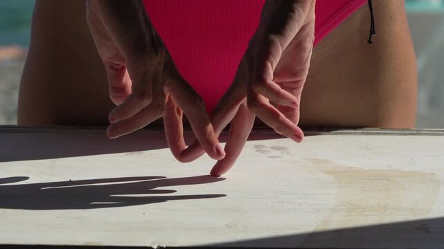 Expressive finger gestures creating rhythmic motions on white surface outdoors. Static close-up shot capturing manual creative storytelling in bright summer sun.