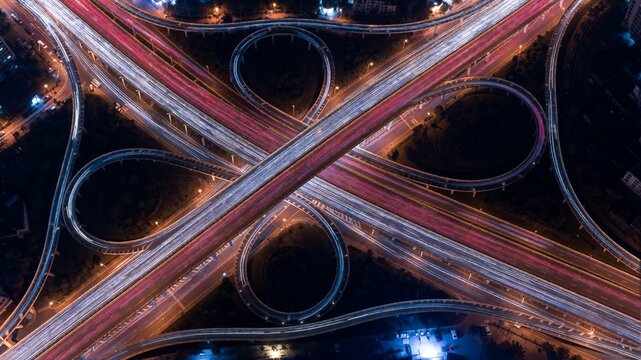 Aerial long exposure view of complex highway interchange at night