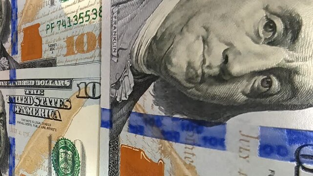 Dynamic movement over crisp 100 dollar banknotes creating an exclusive investment background that emphasizes financial wealth, money management, business strategy and circulating cash