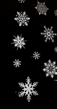 Silver snowflakes pattern on a black glass background