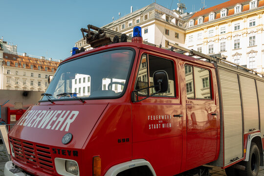Red Vienna fire engine parked in historic city street scene