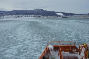 Beautiful landscape of a drift ice icebreaker ship in winter, serene traditional Japanese scenery,Icebreaker sightseeing ship cruising through drift ice in winter, Japan © Sho