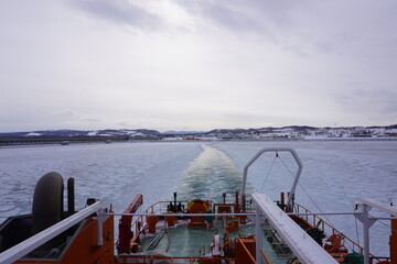Beautiful landscape of an icebreaker bow surrounded by drift ice, serene traditional Japanese scenery,Drift ice covering the Sea of Okhotsk near Hokkaido, Japan © Sho