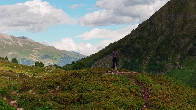 Woman hiker standing on mountain path