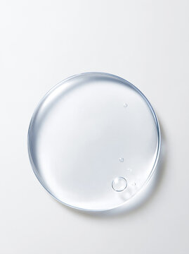 気泡を含む透明な美容液ジェルの丸いスウォッチと高保湿スキンケアイメージ Round clear serum gel swatch with bubbles for hydrating skincare and cosmetic texture