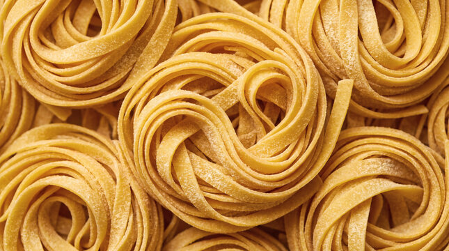 Raw tagliatelle pasta nests dusted with flour arranged in pattern top view