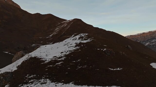 Aerial view of snow dusted mountain landscape