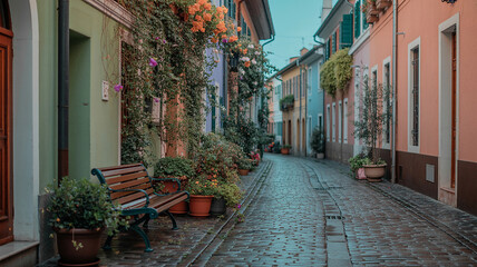 Fototapeta premium Cobblestone street lined with colorful buildings and potted plants