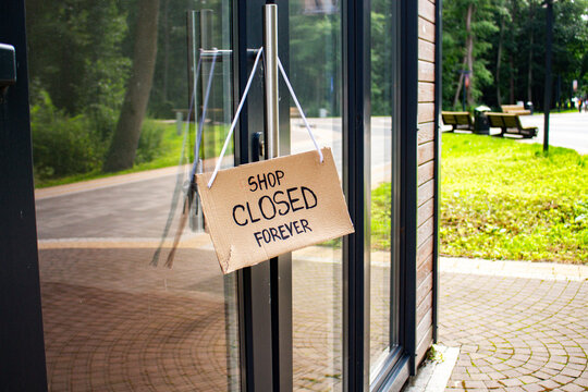 SHOP CLOSED FOREVER sign on private shop window. Small local retail business closes because of financial and economic crisis. Entrepreneurs faces market changes
