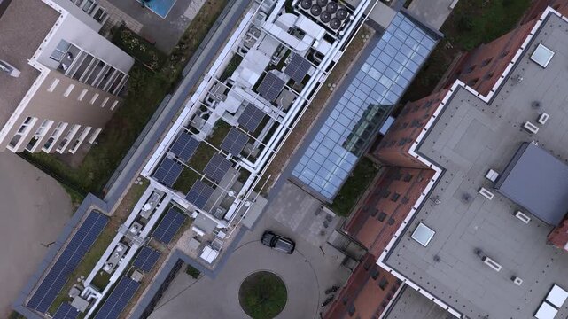 Aerial view of a modern commercial rooftop with solar panels and HVAC systems
