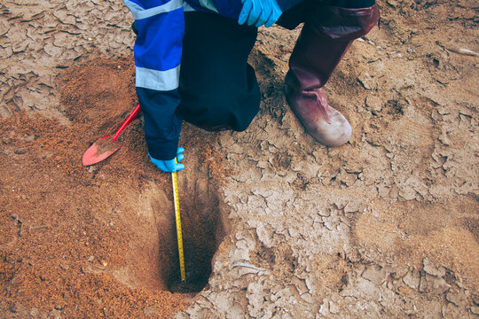 Environmental technician collecting soil samples for quality testing and agricultural assessment.