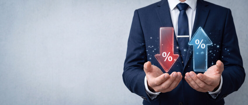 Businessman holding glowing up and down arrows with percentage signs, symbolizing interest rate fluctuations, financial market trends, banking mortgage rates, inflation, and economic growth.