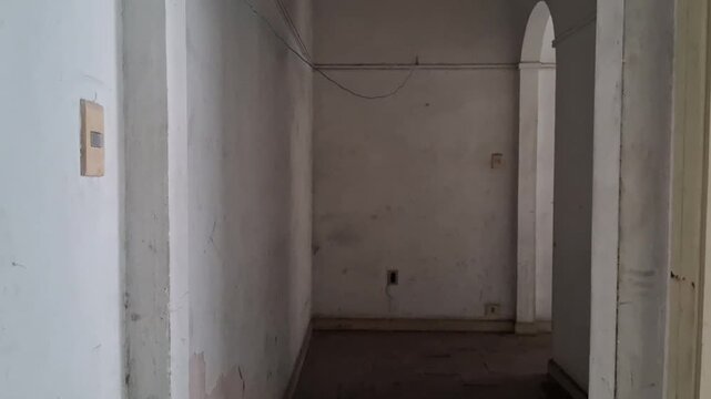 Empty hallway transition showing architectural archway movement
