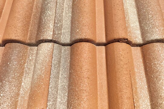 Terracotta clay roof tiles texture with weathered surface
