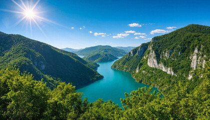 Obraz premium Majestic Mountain River Gorge with Turquoise Water and Radiant Sun