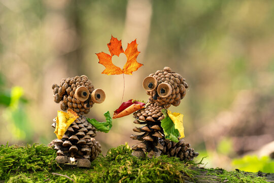 unique handcrafted figures from natural materials like pine cones and acorn in autumn season