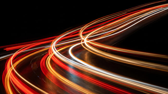 Abstract red and orange light trails moving across a dark background with speed motion