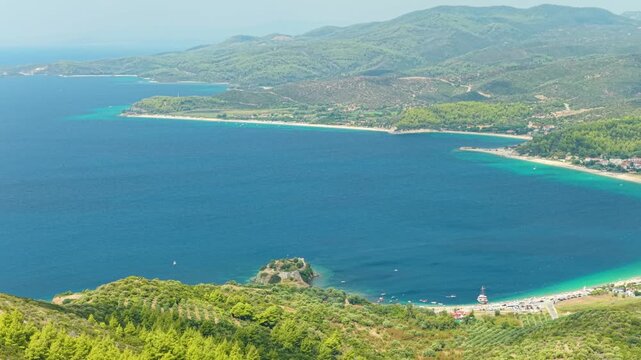 Aerial view of the turquoise waters and sweeping bay of Toroni, a coastal village in Halkidiki, Greece