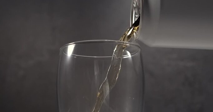 Beer pouring from aluminum can into glass in super slow motion