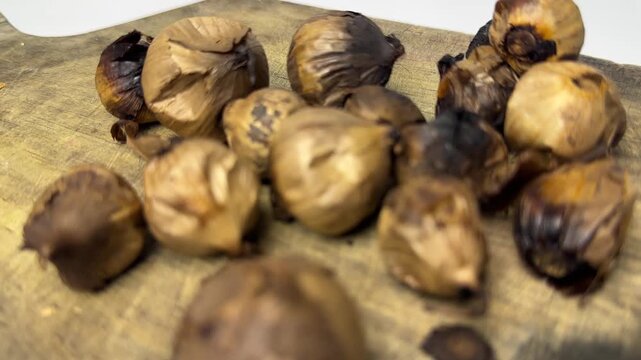 Single clove garlic for herbal medicine on rustic wooden board