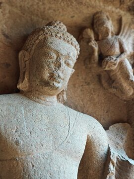 Detailed close-up of ancient stone carved Buddha head at Kanheri