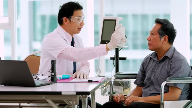 Medical elderly doctor patient eye examination healthcare consultation in Asian adult hospital clinic with diagnostic equipment and supportive care